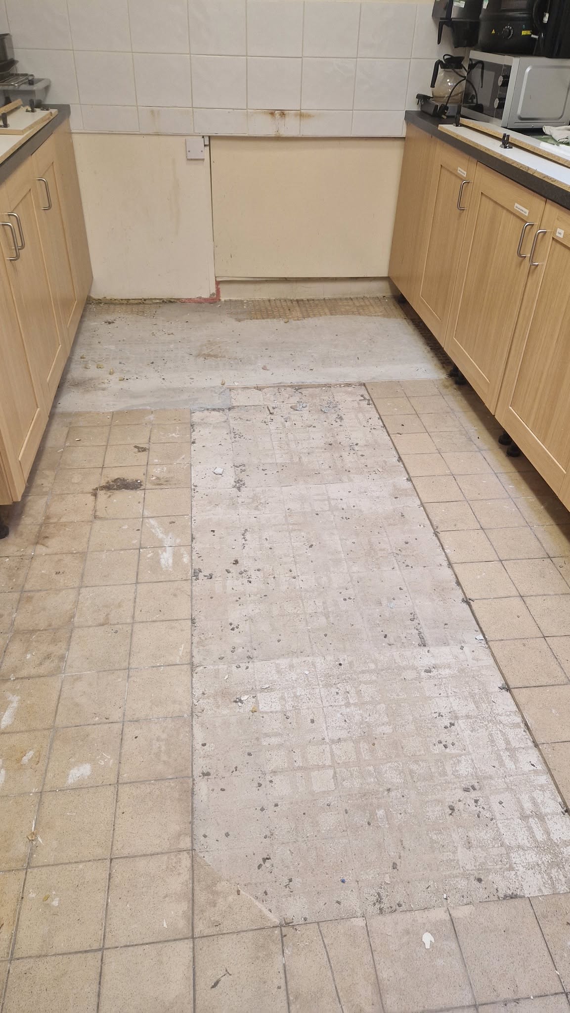 Kitchen before: old floor tiles lifted, ready for the subfloor to be prepared