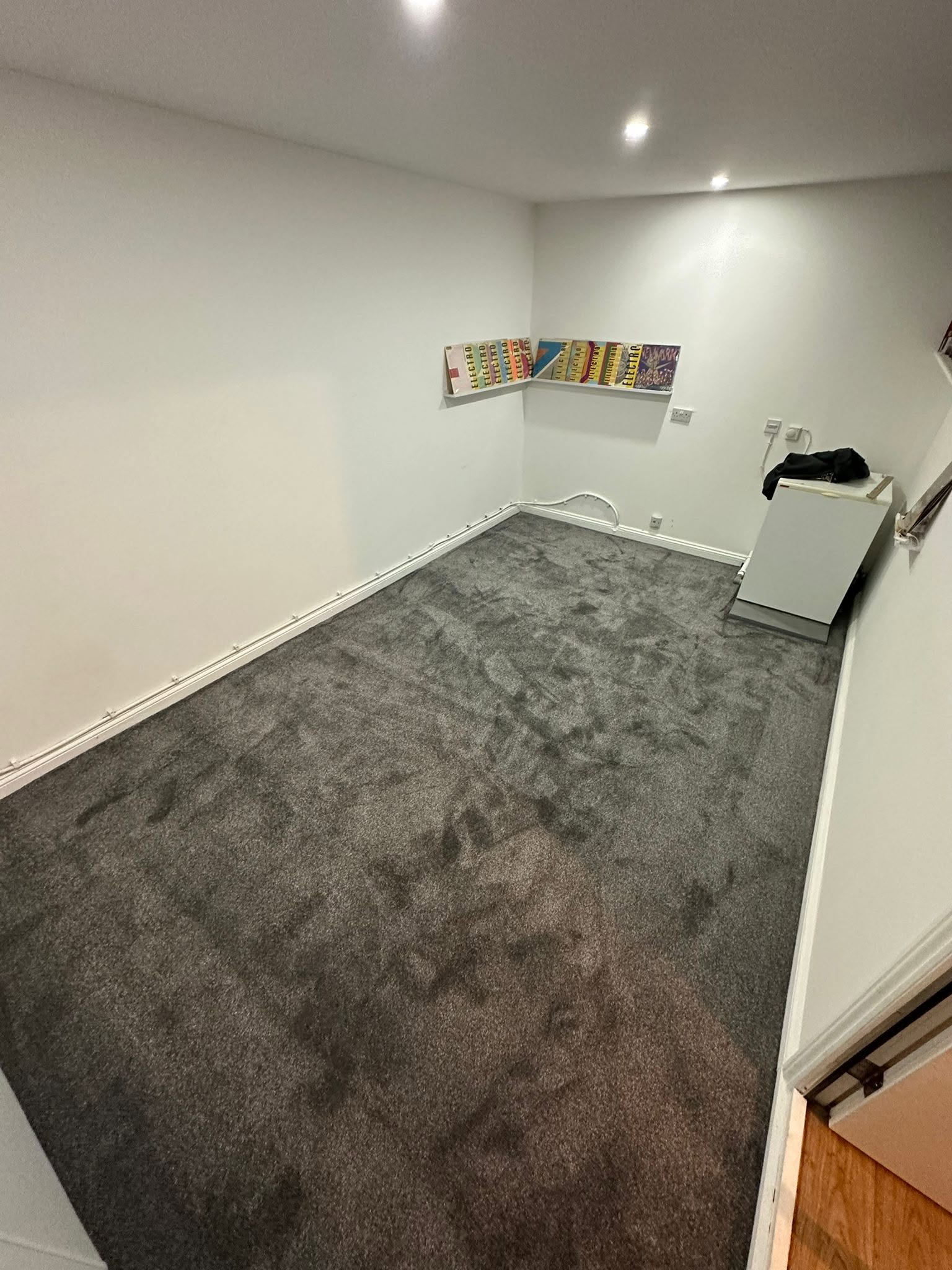Charcoal carpet fitted in a bright room