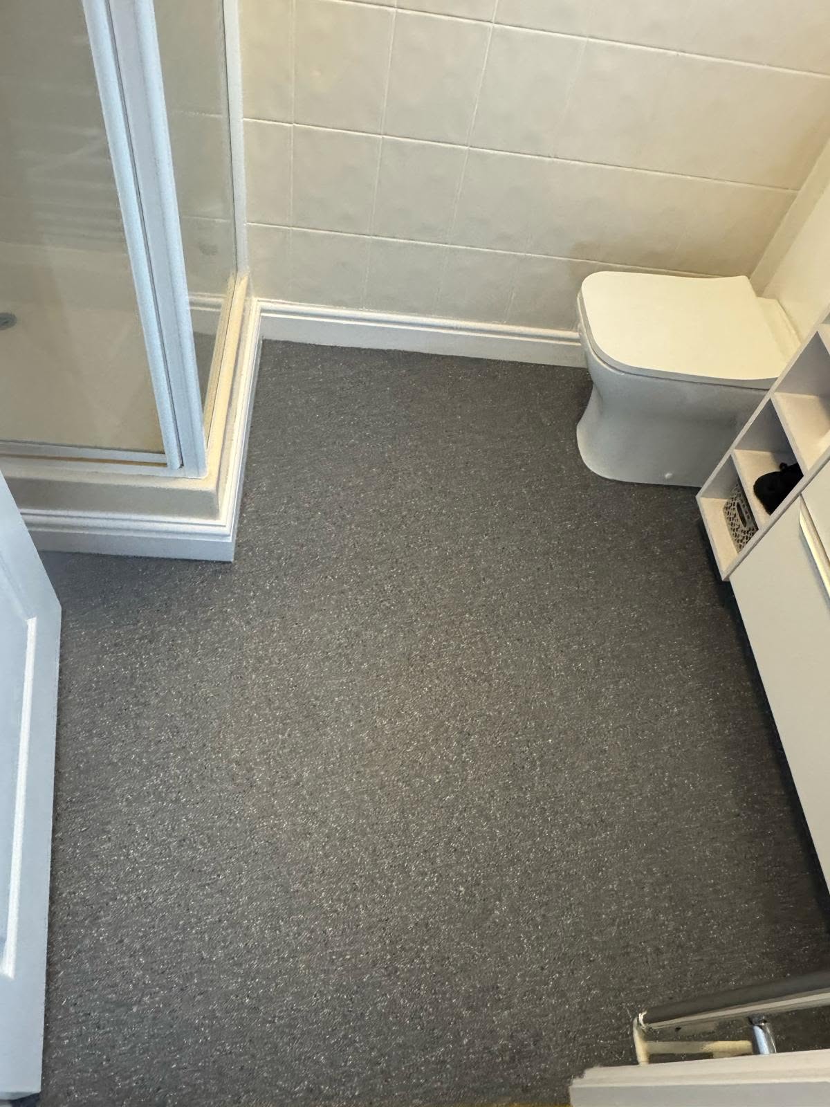 Grey speckled vinyl fitted in a shower room
