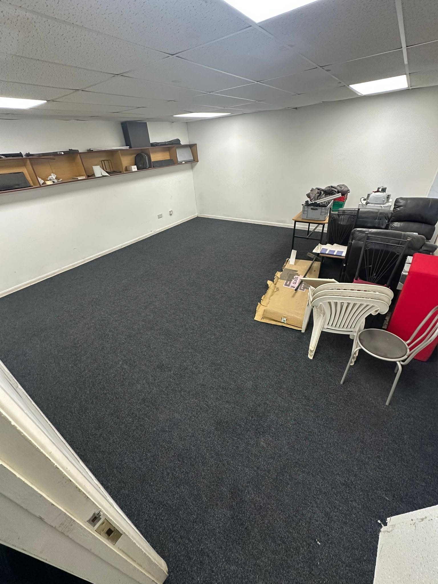 The same room after: dark carpet fitted wall to wall