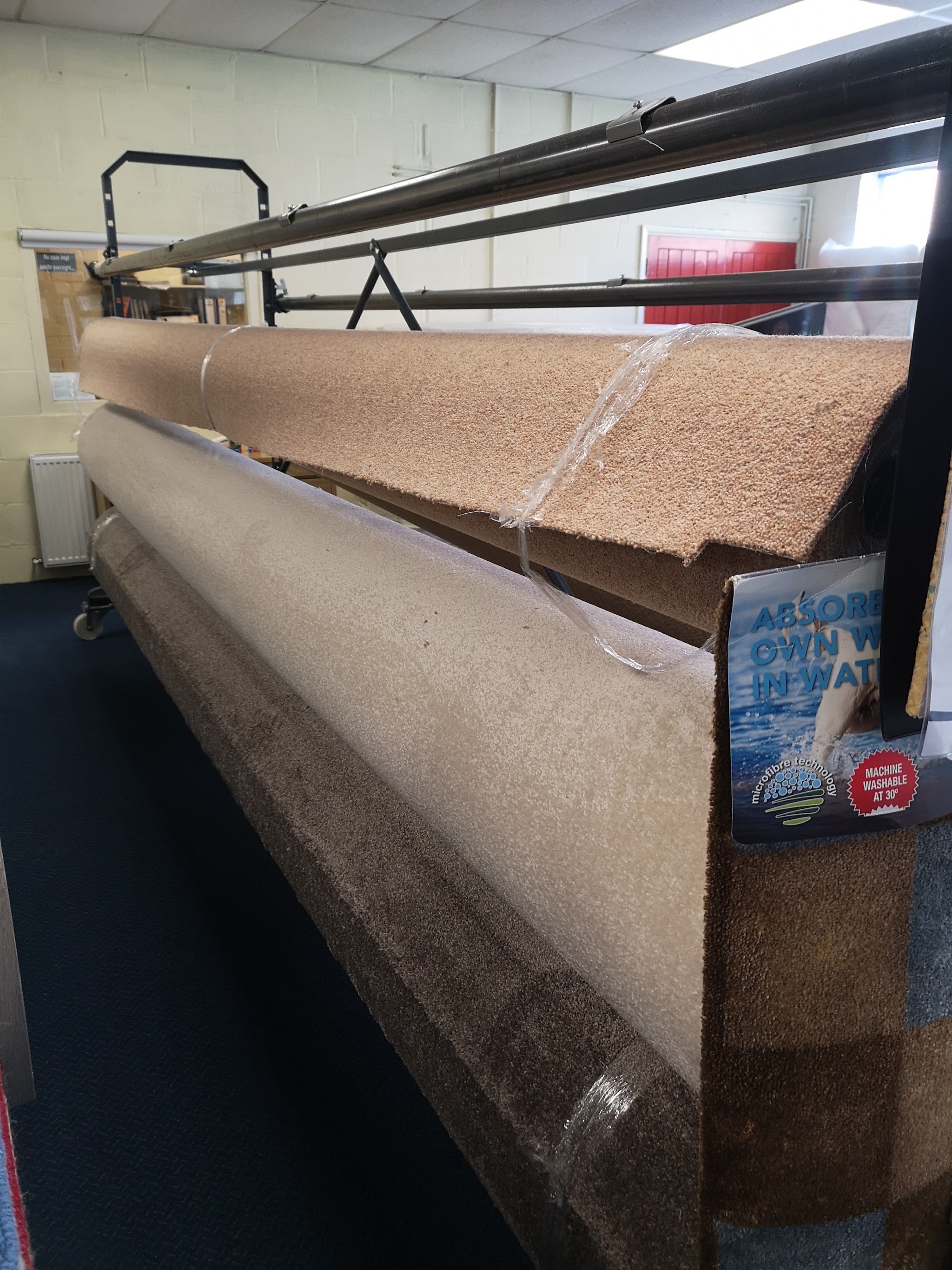 Carpet rolls on the cutting rack in the shop